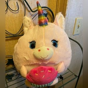 Hug fun plush pink squishmallow Unicorn hugging a cupcake.